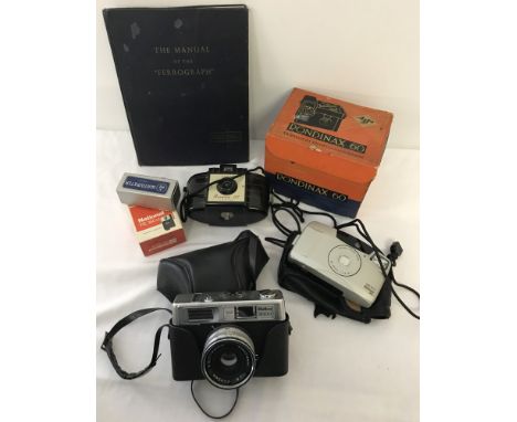 A box of vintage cameras. Comprising:- an Halina 3000, an Agfa Rondinax 60, Kodak Brownie 127, and a Canon Sure Shot 60 Zoom.