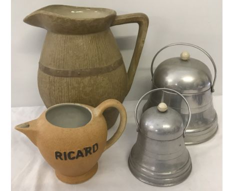Two bell shaped vintage metal cannisters. Together with a large Dee-Cee ceramic jug with faux barrel decoration and a Ricard 