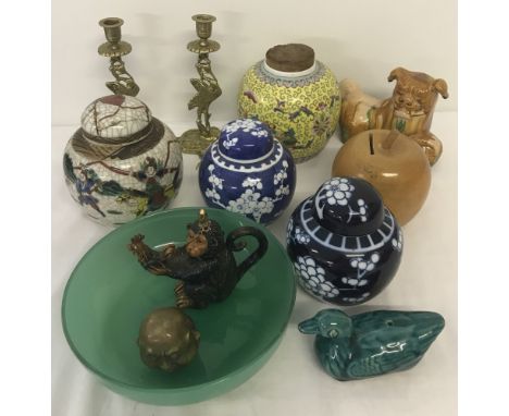 A collection of assorted oriental items to include ceramic ginger jars and brass candle sticks.  