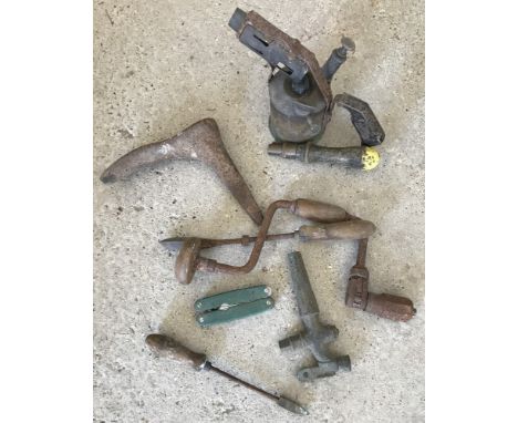 A collection of vintage tools. To include a blow-lamp, a barrel tap, drill etc. 