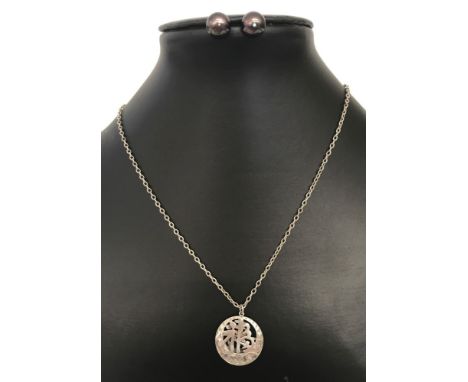 A white metal Chinese symbol pendant on a 25 inch sterling silver trace chain. Together with a pair of Peacock blue freshwate