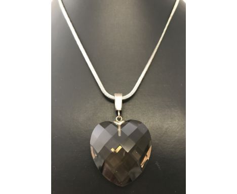 A large smoked quartz heart shaped pendant on a 925 silver omega chain. Bale and fixings to necklace stamped 925. Chain lengt