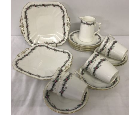 An early 20th century Shelley tea set with black border and pink roses design. Comprising; 6 cups and saucers, 6 side plates,