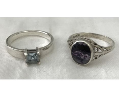 2 silver dress rings. One with cut out scroll work to shoulders set with central Blue John stone. The other set with a centra