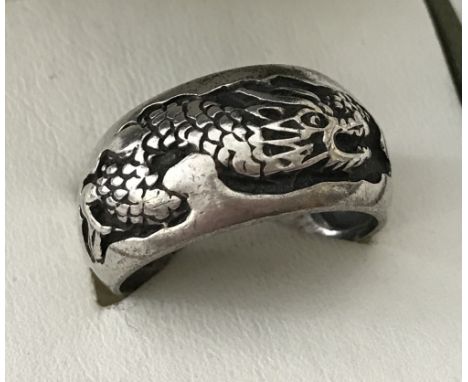 A men's silver band ring decorated with a oriental dragon. Stamped 925. Size R 1/2.