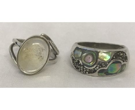 2 silver dress rings. One set with clear quartz the other paua shell and marcasite. Sizes L and O.