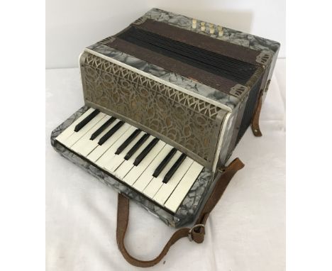 A vintage Ceka - Superior accordion with leather carry strap.  