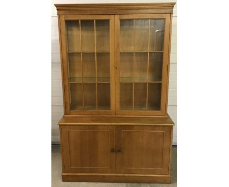 A vintage light oak double glass topped display cabinet. 2 door cupboard to base with interior shelf. Fully glazed front and 