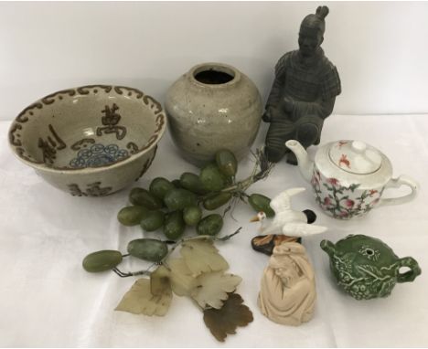 A collection of oriental pieces. To include ceramic 8 peaches teapot, water dropper, provincial stoneware vase and unusual ce