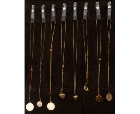 Sixteen various 9ct gold pendants on chains. Including a plain gold disc, a St. Christopher medal, two heart-shaped lockets, 