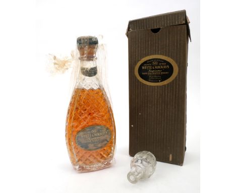 Whyte and Mackay 'Supreme' Rare Old Scotch Whisky. A half-bottle of scotch in presentation bottle with all over hob-nail patt