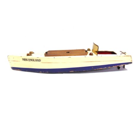 A MODEL SPEED-BOAT, 'MISS ENGLAND'  the hull painted cream over blue with a red waistline, fitted with a clockwork motor (wor