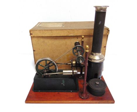 A SPIRIT-FIRED STATIONARY HOT-AIR ENGINE  early 20th century, fitted to a wood plinth base, complete with burner / reservoir 