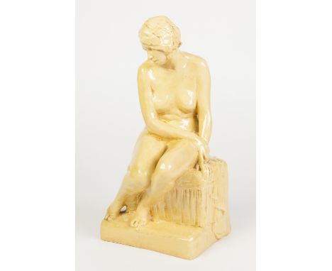 ART DECO POTTERY LADY FIGURINE, the seated nude figure with down turned head and arm draped over her legs, seated on a plinth