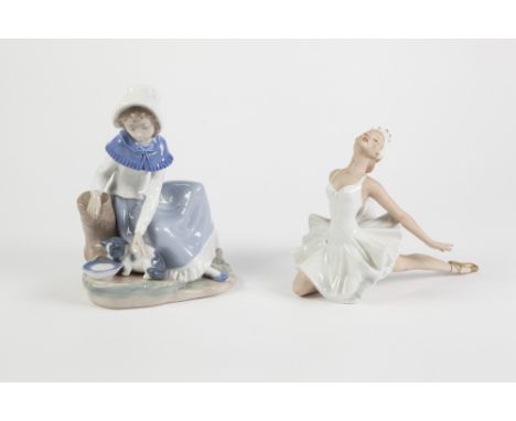 NAO PORCELAIN GROUP, modelled as a young girl with kitten, 7 ¾" (19.7cm) high TOGETHER WITH A FIGURE OF A BALLERINA, 6" (15.2