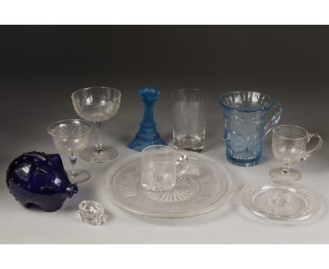 BLUE GLASS MODEL OF A PIGGY BANK, 3 ¼" (8.3cm) high, together with a PALE BLUE MOULDED GLASS CANDLESTICK, in the form of the 