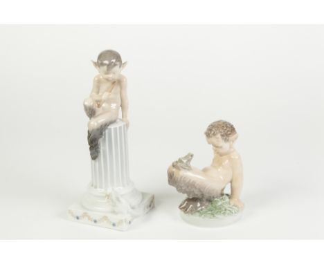 TWO ROYAL COPENHAGEN PORCELAIN FIGURES OF FAWNS, one modelled with pipe, seated on a short fluted pedestal with a rabbit at t