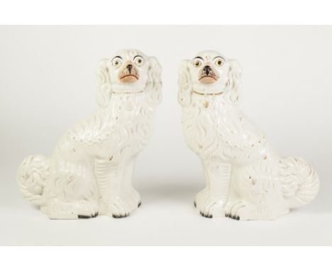 PAIR OF VICTORIAN STAFFORDSHIRE POTTERY MANTEL DOGS, of typical form with pink muzzles and gilt details, 12 1/2" (31.8cm) hig