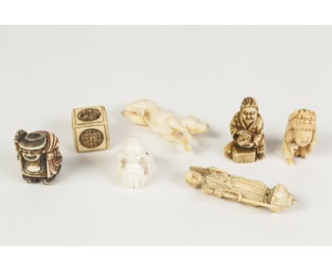 A JAPANESE MEIJI PERIOD CARVED IVORY NETSUKE, in the form of a crouching figure beneath a shi-shi headed cloak (damaged), TWO