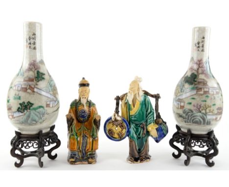 A pair of famille rose vases; each one decorated with a group of scholars in a mountainous landscape, 25.5 cm high; together 