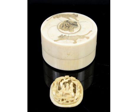 Early 20th century Japanese ivory small circular box and cover, decorated with tigers, 6.5cm diameter, and a relief carved ov