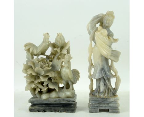 Two Chinese soapstone sculpture: one carved as a standing girl holding a rabbit and wearing a celestial scarf, 24 cm high; th