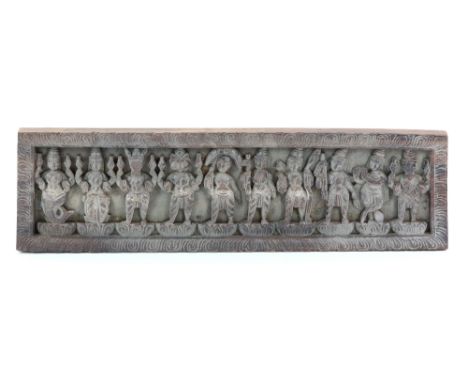 A rectangular wood carving, decorated with ten standing figures, possibly a manuscript cover, 60 x 17 cm.         