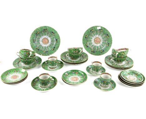 A Canton famille rose part service, decorated with butterflies on a green ground, comprising: four coffee cups; eight tea cup