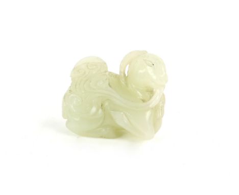 A small green jade, carved as a seated goat, holding a fungus [or other object] beside its young; 5 cm long, post Qing Dynast