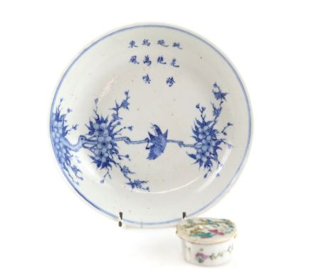 A Chinese blue and white dish, decorated with a bird on plum blossom beneath a three-line poem, the base with four-character 