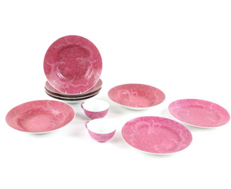 Eight dishes, all about 23 cm diameter, decorated with dragons on a ruby-red ground; together with two teacups en-suite; all 