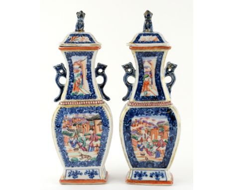 A pair of Chinese Export vases; each one with a  domed cover and mythological animal finial; both vases decorated with panels