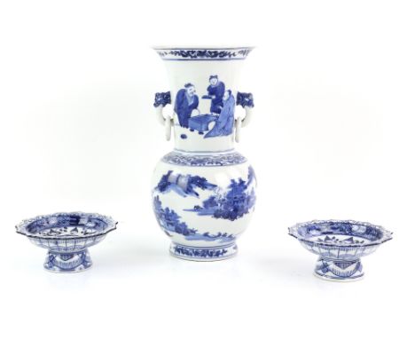 A blue and white vase with trumpet neck and loose-ring handles, decorated with a mountainous river landscape beneath a group 