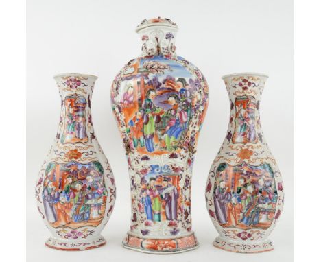 An elegant, associated garniture of three Chinese Export, famille rose vases; each one decorated with panels depicting Manchu