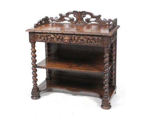 A Victorian carved oak serving table
The rectangular cleated plank top with a scrolling leafy gallery, leaf carved border abo