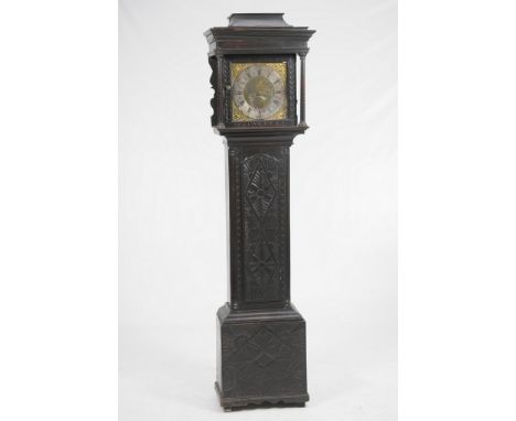 An 18th Century oak and later carved ebonised longcase clock
With a 31cm brass dial signed Will Barnish, Rochdale with Roman 