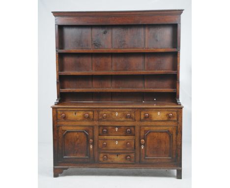 A late George III oak and inlaid high dresser
North Wales the boarded rack with an ovolo cornice above a plain frieze and thr