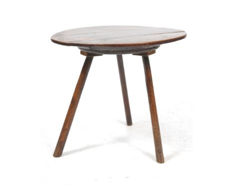 A primitive late 18th early 19th Century oak and elm cricket table
With a 66.5cm three plank top with an elm roundel boss and