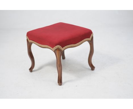 A Victorian walnut dressing stool
With a red velvet stuff over seat raised upon four curvilinear legs and shaped feet 48 x 53