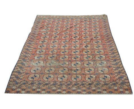 A North West Persian  carpet
With guard stripes the red field with six rows of thirteen shaped guls worn, 250x192cms. CONDITI