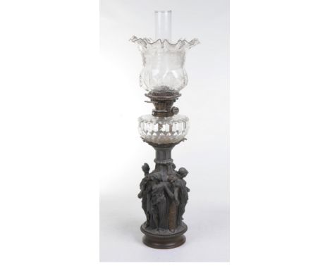 A Victorian Spelter and cut glass table lamp
With a beaded circular base above a  fluted vase embraced by four classical maid