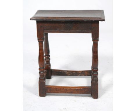 A Charles II and later oak joint stool
The rectangular board seat with a moulded edge above channel edge-moulded rails raised