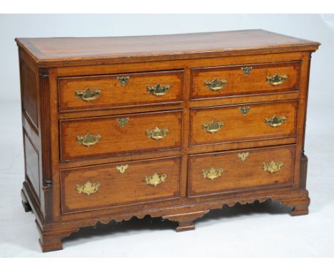 An 18th Century oak and mahogany crossbanded dresser
The rectangular plank top with a broad mahogany border above a plain fri