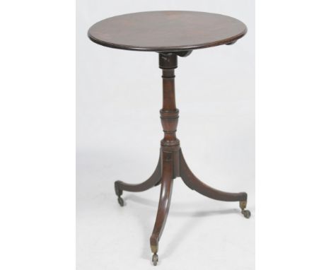 A Georgian mahogany tilt top tripod occasional table 
The single plank circular top with bevelled edging, extending to a turn