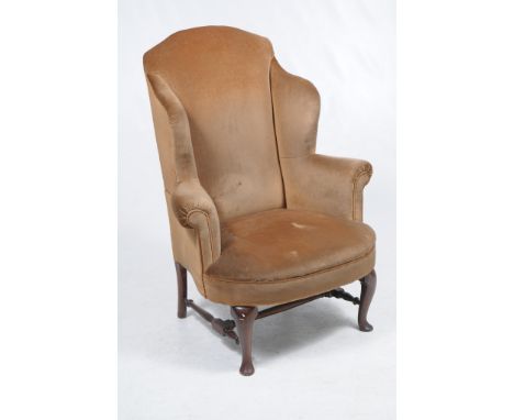 A George III style mahogany wing elbow chair
With padded back out swept wing arms bow front padded seat raised upon front mah