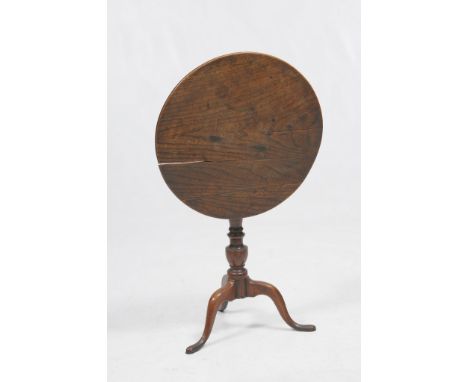 A George III elm tilt top tripod table
The circular well figured tilt top, raised on a turned baluster central stem, and rais