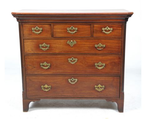 A George III mahogany chest of drawers
The rectangular top with a canted ogee moulded frieze above an arrangement of three sh