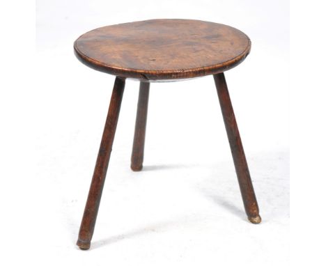A 19th Century primitive fruit wood and ash cricket table
The near circular deep top raised on three circular section legs an