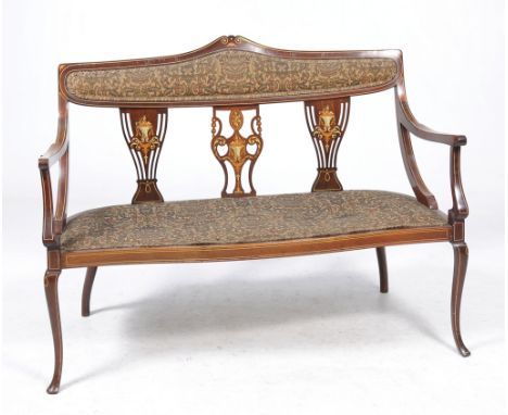 An Edwardian inlaid mahogany satinwood and ivory settee
With a shaped tapestry padded back above a vase shaped splat flanked 