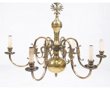 A brass six branch chandelier
The baluster shaft with an outstretched eagle surmount each branch with dolphins and screw in f